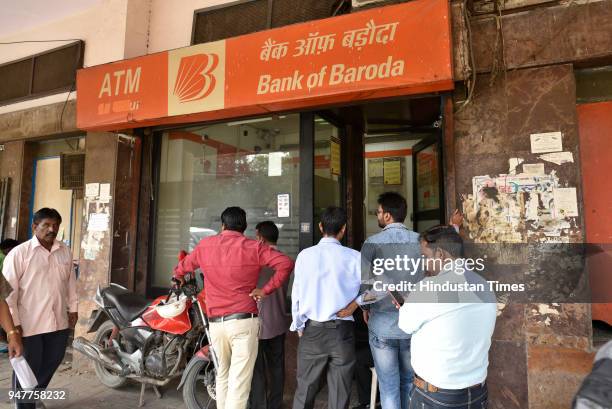 People queue outside ATM due to cash crunch at Paharganj, on April 17, 2018 in New Delhi, India. Reports of a cash crunch in several states including...