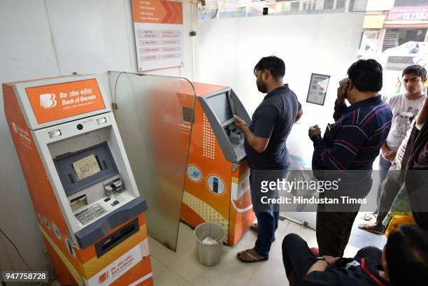 People queues outside ATM due to cash crunch at Paharganj on April 17, 2018 in New Delhi, India. Reports of a cash crunch in several states including...