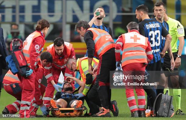 Roberto Gagliardini of FC Internazionale Milano receives medical care during the serie A match between FC Internazionale and Cagliari Calcio at...