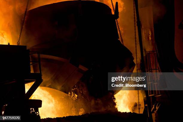 Bucket empties a load of scrap metal into an electric arc furnace at the NLMK Indiana facility in Portage, Indiana, U.S., on Friday, April 13, 2018....