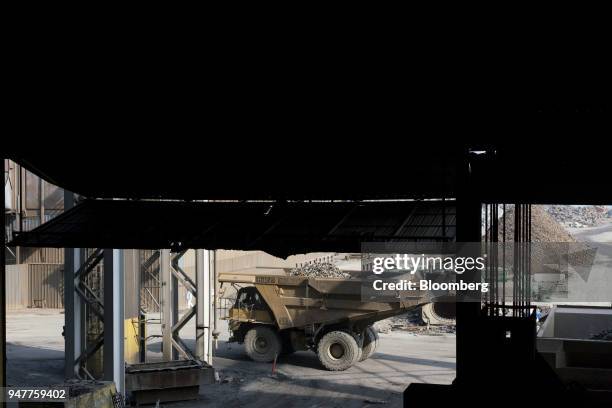 Dump trucks carry scrap metal toward an electric arc furnace at the NLMK Indiana facility in Portage, Indiana, U.S., on Friday, April 13, 2018....