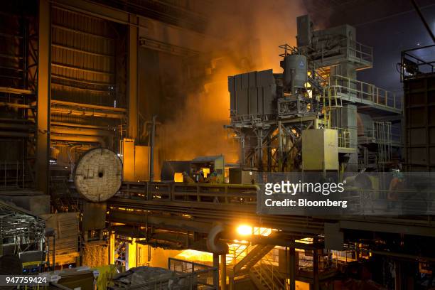 Employees stand near an electric arc furnace at the NLMK Indiana facility in Portage, Indiana, U.S., on Friday, April 13, 2018. Novolipetsk Steel...