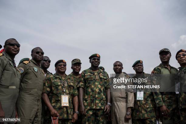 Nigerian Lieutenant General and the current Chief of Army Staff of Nigeria Tukur Yusuf Buratai stands surrounded by members of the Nigerian Armed...