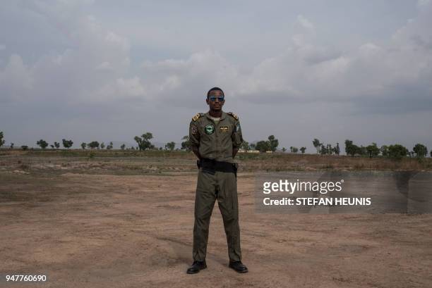 Nigerian Airforce helicopter pilot poses for a photo at the African Land Forces Summit military demonstration held at General Ao Azazi barracks in...