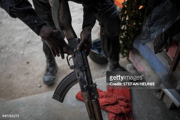 Member of the Nigerian Special Forces Unit reassembles an AK-47 assault rifle during the African Land Forces Summit military demonstration held at...