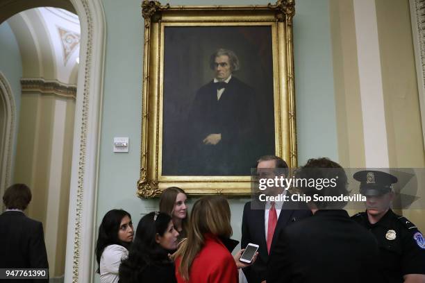 Sen. John Thune talks with reporters before stepping into the weekly Republican policy luncheon at the U.S. Capitol April 17, 2018 in Washington, DC....