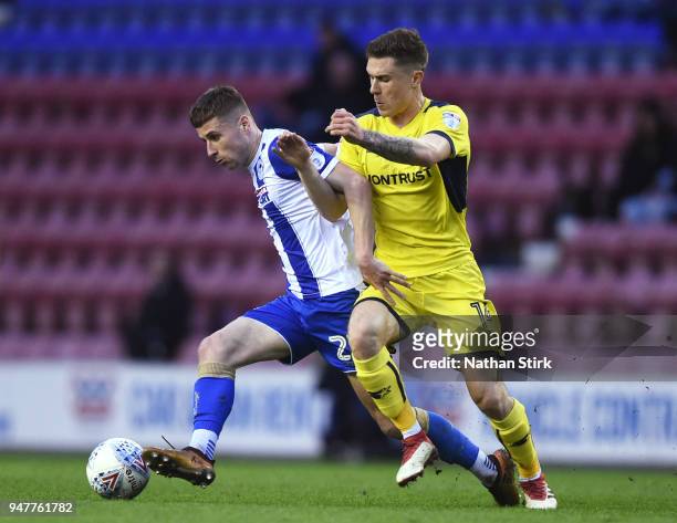 Ryan Colclough of Wigan Athletic and Josh Ruffels of Oxford United in action during the Sky Bet League One match between Wigan Athletic and Oxford...