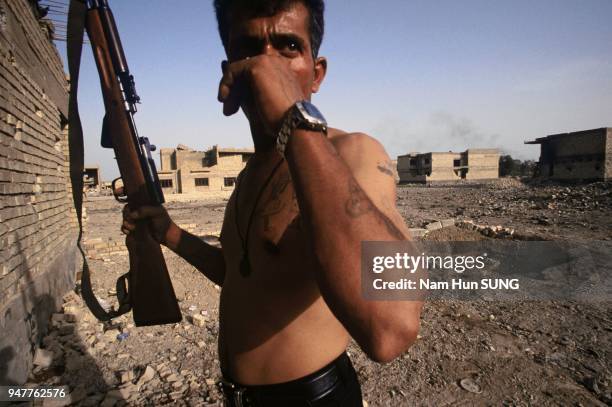 Reyadh, a veteran of the first Gulf war returns to his neighborhood. He has kept his weapon to protect himself against looters. May 2003. Al Amen,...