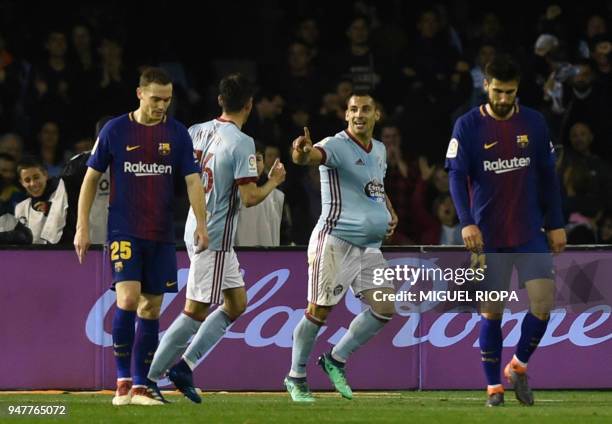 Celta Vigo's Spanish defender Jonny Castro celebrates a goal between Barcelona's Belgian defender Thomas Vermaelen and Portuguese midfielder Andre...