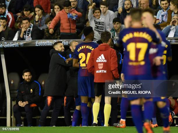 Barcelona's Argentinian forward Lionel Messi looks from the bench at teammates celebrating the opening goal during the Spanish league football match...