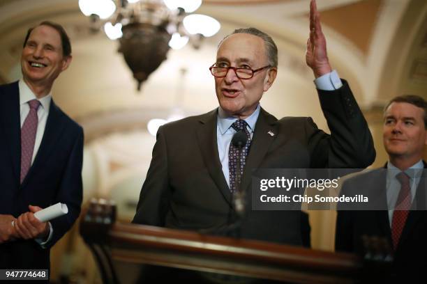 Sen. Ron Wyden , Senate Minority Leader Charles Schumer and Sen. Michael Bennet talk with reporters following the weekly Democratic policy luncheon...