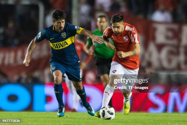 Pablo Perez of Boca Juniors and Martin Benitez of Independiente battle for the ball during a match between Independiente and Boca Juniors as part of...