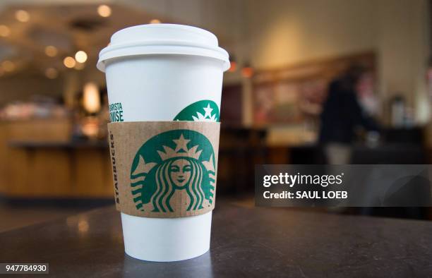 Starbucks coffee cup is seen inside a Starbucks Coffee shop in Washington, DC, April 17 following the company's announcement that they will close...