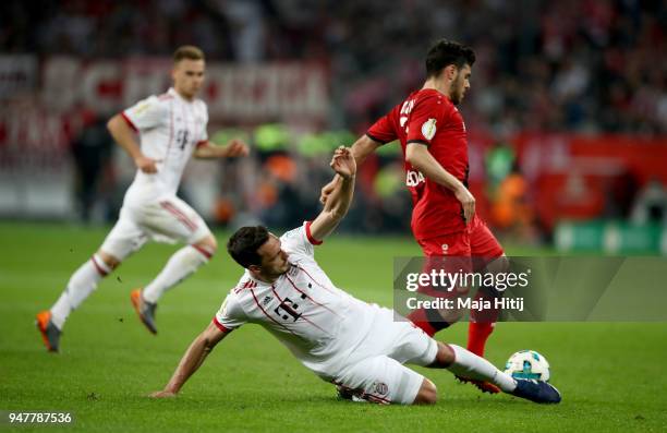 Kevin Volland of Leverkusen and Mats Hummels of Muenchen battle for the ball during the DFB Cup semi final match between Bayer 04 Leverkusen and...