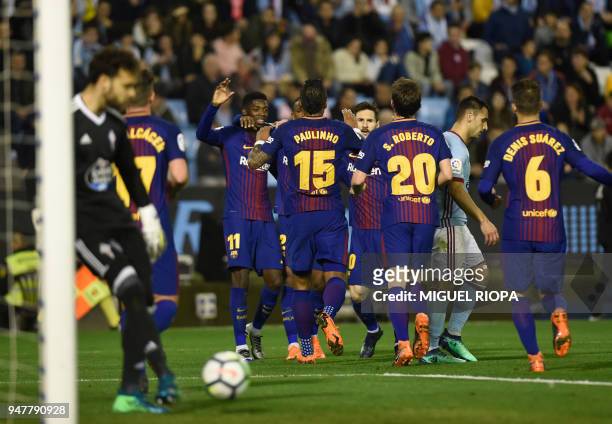 Barcelona players celebrate a goal scored by Spanish forward Paco Alcacer during the Spanish league football match between RC Celta de Vigo and FC...