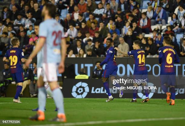 Barcelona's French forward Ousmane Dembele celebrates the opening goal during the Spanish league football match between RC Celta de Vigo and FC...