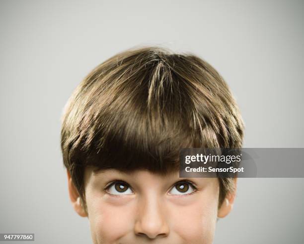 portrait of a caucasian real boy looking up. - mischief stock pictures, royalty-free photos & images