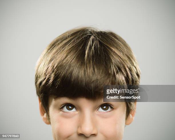 portrait of a caucasian real boy looking up. - react imagens e fotografias de stock