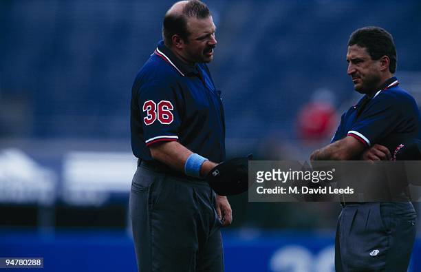 Umpires Wally Bell and Mark Hirschbeck speak before the New York Yankees game against the Chicago White Sox at Yankee Stadium on June 18, 2000 in the...