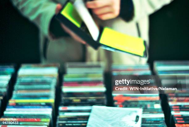 person choosing cds and dvds in a music store, shanghai, china - dvd stock pictures, royalty-free photos & images