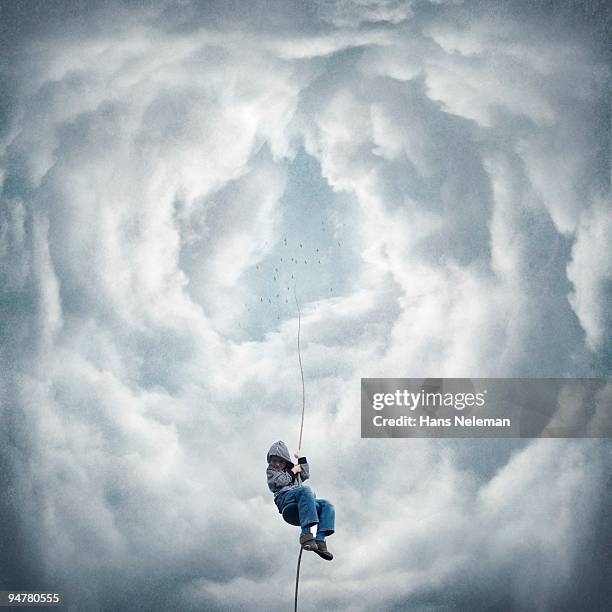 boy moving down from the sky on a rope, republic of ireland - surreality stock pictures, royalty-free photos & images