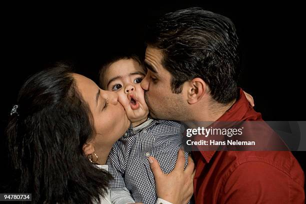 parents kissing their son - funny baby boy stock pictures, royalty-free photos & images