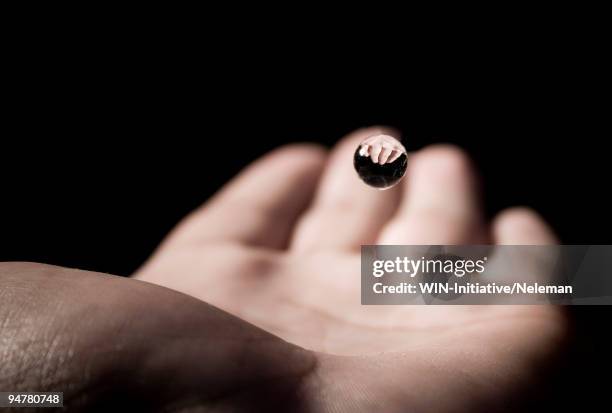 close-up of a water drop falling on a person's palm - catching hands stock pictures, royalty-free photos & images