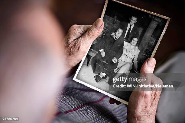 person looking at a photograph, argentina - vergangenheit stock-fotos und bilder