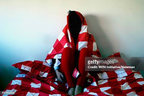 woman sitting on the bed covered with a red linen, buenos aires, argentina - woman pillow over head stock pictures, royalty-free photos & images