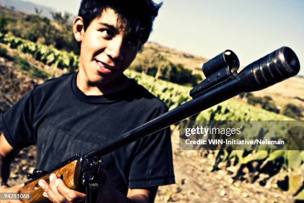 man holding a shotgun, cocoyoc, mexico - generic mexico stock pictures, royalty-free photos & images