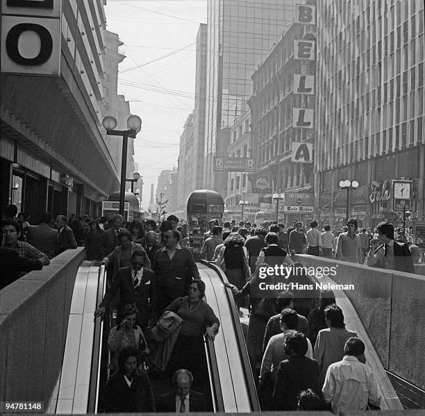 people moving on escalators at a subway exit, ahumada street, santiago, chile - santiago chile street stock pictures, royalty-free photos & images
