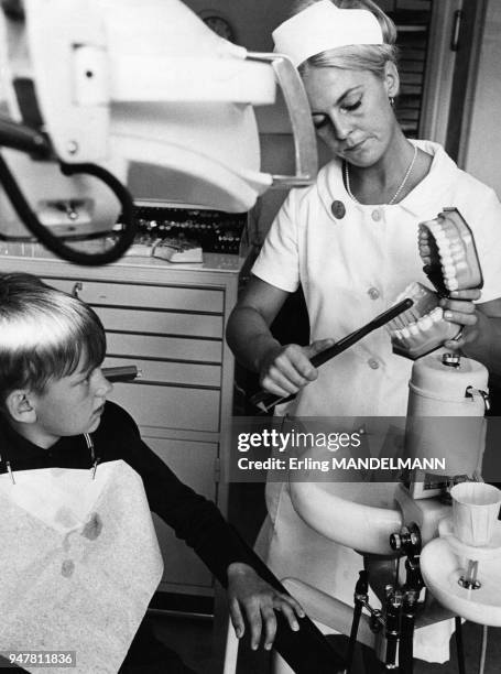 Dentiste apprenant le brossage des dents à un enfant en Suède.