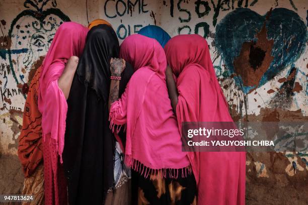 Young Somali refugee women stand together at Dadaab refugee complex, in the north-east of Kenya, on April 16, 2018. The Dadaab refugee complex which...