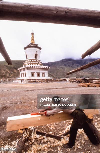Menuisier devant un stupa au Tibet, Chine.