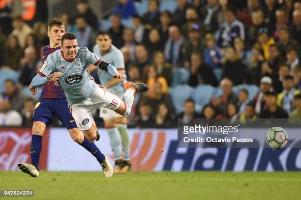 Iago Aspas of Celta de Vigo competes fo the ball with Lucas Digne of Barcelona during the La Liga match between Celta de Vigo and Barcelona at...