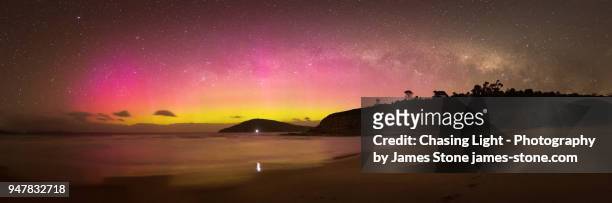 colourful aurora australis and milky way panorama over beach scene - aurora australis stock pictures, royalty-free photos & images