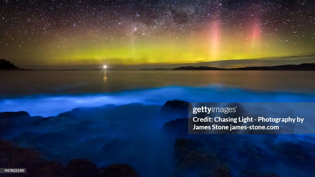 Aurora Australis over blue bioluminescence