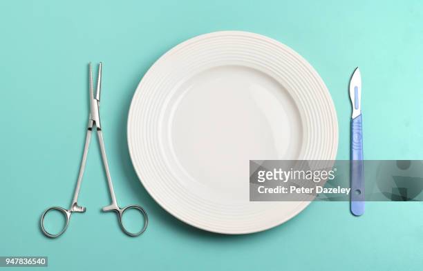 hospital food with medical pincers and scalpel by plate - surgical tools stock pictures, royalty-free photos & images