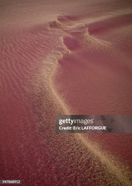 Pink sand in Namib desert, Angola The Namib Desert is a desert in Namibia and southwest Angola. The name "Namib" is of Nama origin and means vast....