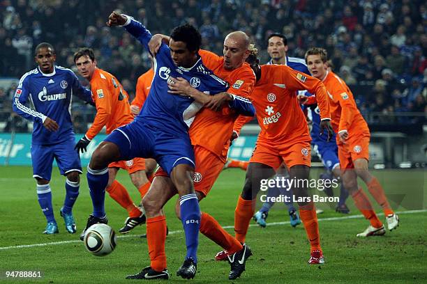 Joel Matip of Schalke is challenged by Elkin Soto of Mainz during the Bundesliga match between FC Schalke 04 and FSV Mainz 05 at Veltins Arena on...