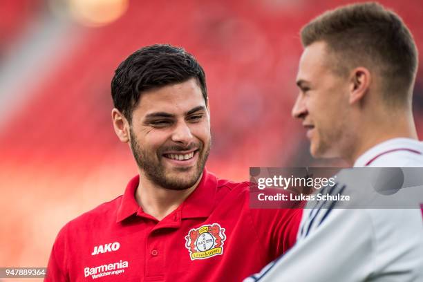 Kevin Volland of Leverkusen talks to Joshua Kimmich of Munich prior to the DFB Cup semi final match between Bayer 04 Leverkusen and Bayern Muenchen...