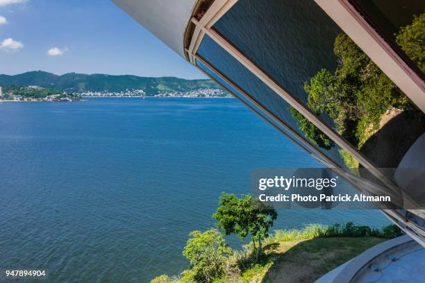 windows of the museum of contemporary art rounded building in the city of niterói located across the bay of rio de janeiro, brazil - the niteroi contemporary art museum stock pictures, royalty-free photos & images