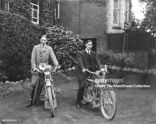 Two young men posing in an English country garden beside their motorcycles, the motorcycle on the right being the British made Triumph motorcycle and...
