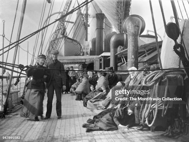 Group of passengers huddled under blankets on ships deck during a transatlantic crossing circa 1895.