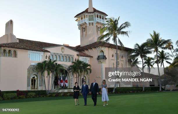 President Donald Trump and First Lady Melania Trump greet Japan's Prime Minister Shinzo Abe and wife Akie Abe as they arrive for dinner at Trump's...