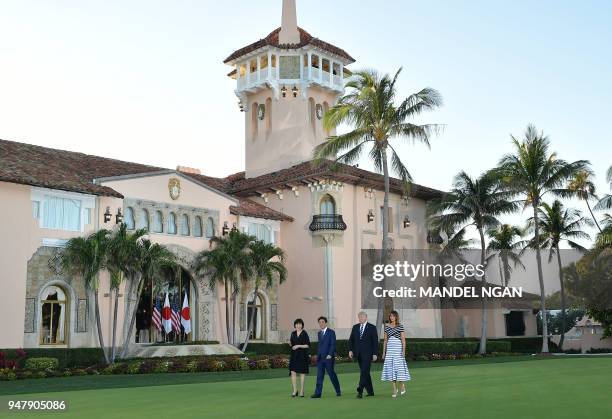 President Donald Trump and First Lady Melania Trump walk with Japan's Prime Minister Shinzo Abe and wife Akie Abe as they arrive for dinner at...