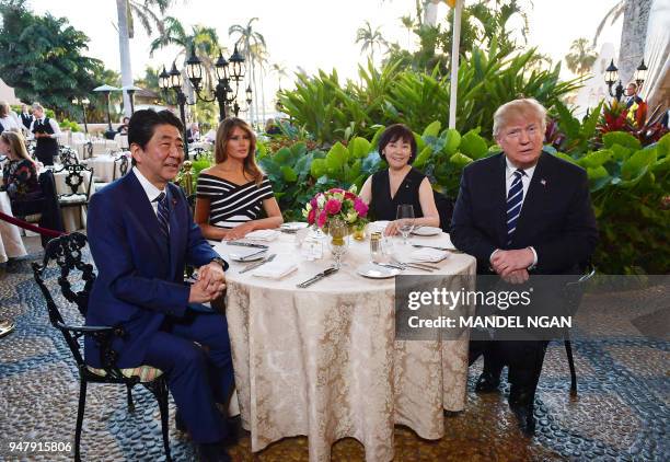 President Donald Trump and First Lady Melania Trump are seated for dinner with Japan's Prime Minister Shinzo Abe and wife Akie Abe at Trump's...