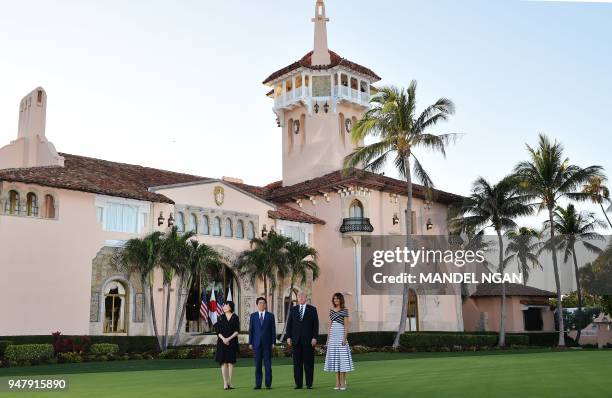 President Donald Trump and First Lady Melania Trump greet Japan's Prime Minister Shinzo Abe and wife Akie Abe pose for a phot as they arrive for...