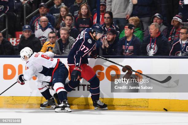 Josh Anderson of the Columbus Blue Jackets skates the puck past Dimitry Orlov of the Washington Capitals during the first period in Game Three of the...