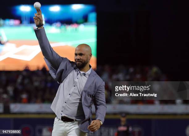 Former MLB player and Puerto Rico native Carlos Beltran throws out the ceremonial first pitch during the pregame ceremony before the game between the...
